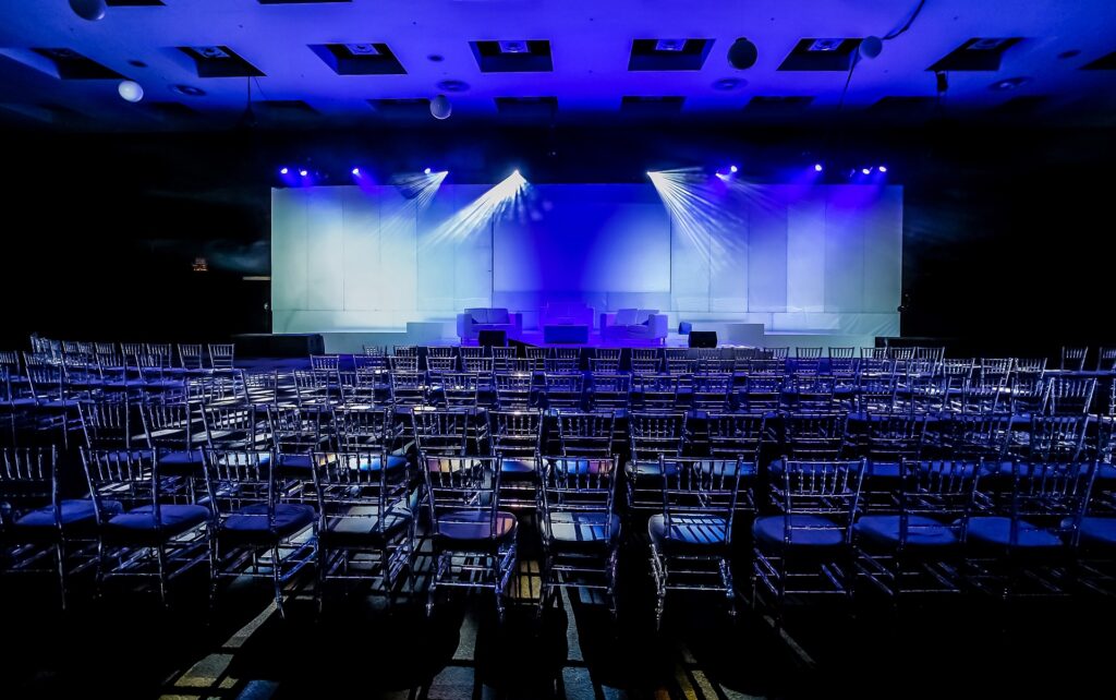 The rows of seats at an empty conference center with a stage